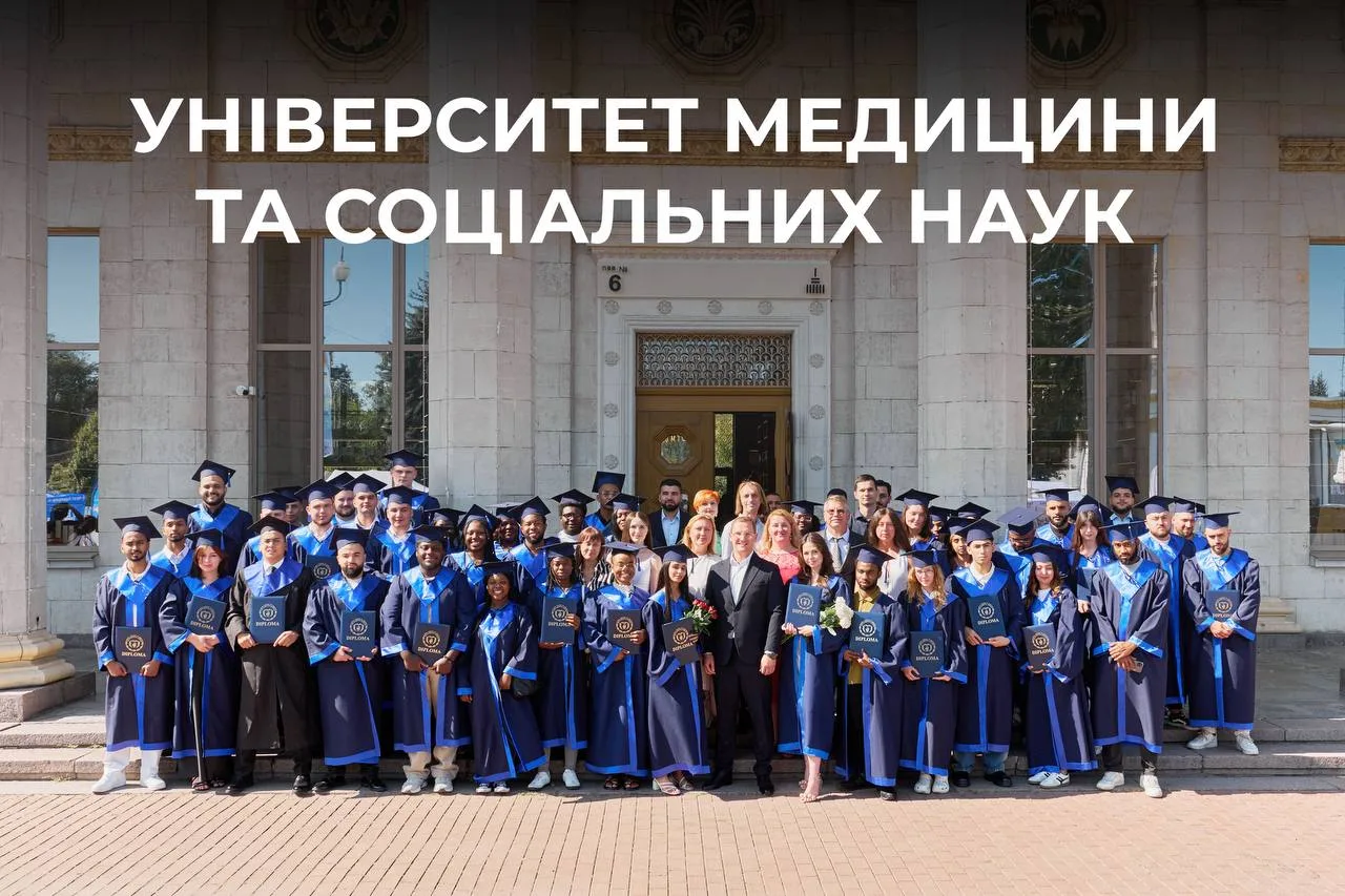 Група студентів у синіх мантіях перед будівлею університету
