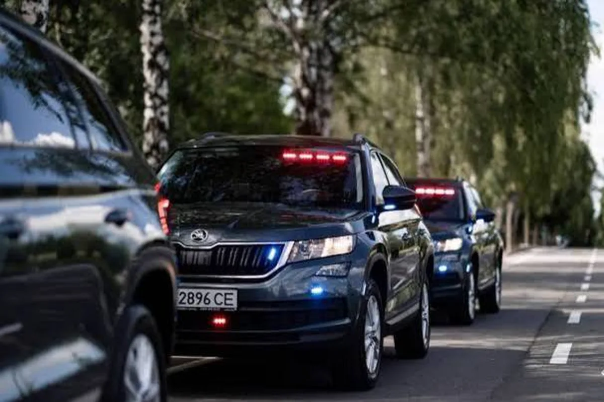 Колона автомобілів поліції з увімкненими сигналами на дорозі