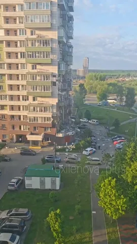 Багатоповерховий житловий будинок з паркінгом та озеленення внизу