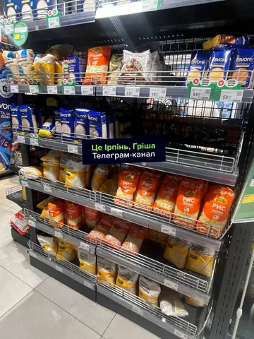 Полиця супермаркету з частково порожніми місцями для продуктів